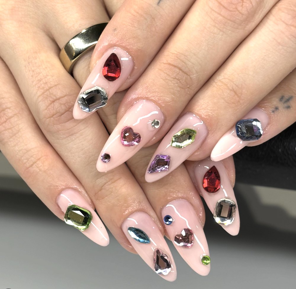 Almond nails covered in multicolor gems