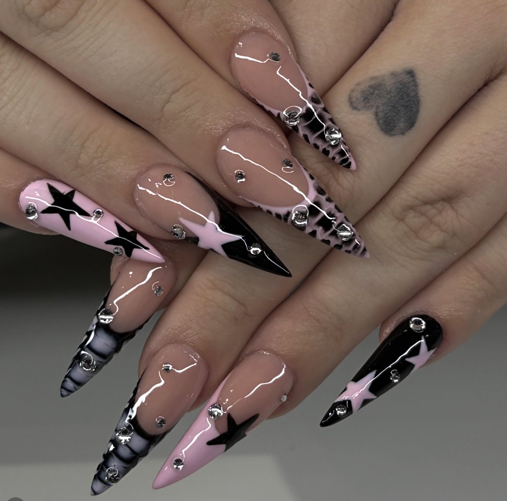 Long stiletto nails in pink and black with stars and rhinestones